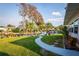 Well manicured lawn with mature trees and private dock along the water at 920 Morningview Dr, Tavares, FL 32778