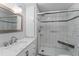 Bathroom with marble sink, walk-in shower, silver accents, and plenty of storage at 920 Morningview Dr, Tavares, FL 32778
