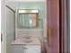 Bathroom with a modern sink, mirror, and shower, offering convenience and style at 920 Morningview Dr, Tavares, FL 32778