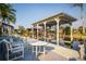 Outdoor patio with table and chairs on the waterfront dock for serene relaxation and entertainment at 920 Morningview Dr, Tavares, FL 32778