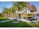 Back yard with waterfront view, mature palm trees, and dock with boat lift at 920 Morningview Dr, Tavares, FL 32778