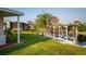Waterfront home featuring a covered dock, lush landscaping, and a well-maintained lawn at 920 Morningview Dr, Tavares, FL 32778