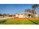 Charming single-story home with well-maintained landscaping and a convenient carport at 920 Morningview Dr, Tavares, FL 32778
