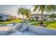 Exterior of home with patio, stairs and well-manicured lawn and garden at 920 Morningview Dr, Tavares, FL 32778