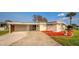 Property features convenient covered parking and colorful landscaping at 920 Morningview Dr, Tavares, FL 32778