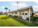 Well-maintained exterior with green lawn, garden and long covered porch at 920 Morningview Dr, Tavares, FL 32778