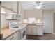 Well-maintained kitchen featuring bright white cabinetry and modern fixtures at 920 Morningview Dr, Tavares, FL 32778