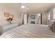 Well-lit bedroom showcases a comfortable bed, adjoining bathroom, and ample closet space at 920 Morningview Dr, Tavares, FL 32778