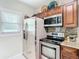 Modern kitchen with stainless steel appliances and wood cabinets at 962 2Nd Pl, Longwood, FL 32750