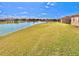 Expansive backyard featuring well-manicured lawn and serene waterfront views at 10177 Mainsail Dr, Oxford, FL 34484