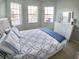 Comfortable bedroom with natural light, a comfortable bed, and stylish furnishings at 10177 Mainsail Dr, Oxford, FL 34484