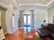 Inviting entryway showcasing double doors, arched entryway and beautiful tile flooring at 10177 Mainsail Dr, Oxford, FL 34484