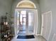 Welcoming foyer featuring tile flooring, display shelving, and natural light at 10177 Mainsail Dr, Oxford, FL 34484