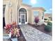 Inviting entryway showcasing a brick pathway, decorative door, and manicured landscaping at 10177 Mainsail Dr, Oxford, FL 34484