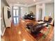 Open-concept living room featuring hardwood floors, neutral walls, and comfortable seating at 10177 Mainsail Dr, Oxford, FL 34484