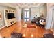 Spacious living room with hardwood floors, tray ceiling, ceiling fan and large windows at 10177 Mainsail Dr, Oxford, FL 34484