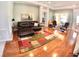 Comfortable living room with hardwood floors, seating, and access to the outdoor patio at 10177 Mainsail Dr, Oxford, FL 34484