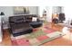Comfortable living room with hardwood floors, seating, and a decorative painting at 10177 Mainsail Dr, Oxford, FL 34484