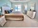 Spacious main bedroom featuring neutral décor, a large window, and a walk-in closet at 10177 Mainsail Dr, Oxford, FL 34484