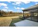 The backyard features a peaceful view of the water and a screened-in lanai at 5449 Dray Dr, The Villages, FL 32163