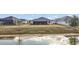 A backyard with a lake view, and a screened-in porch at 5449 Dray Dr, The Villages, FL 32163