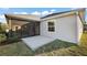 A cozy patio and screened-in porch create an inviting outdoor space at 5449 Dray Dr, The Villages, FL 32163
