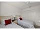 Bright bedroom featuring twin beds, ceiling fan, and neutral carpeting at 5449 Dray Dr, The Villages, FL 32163