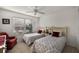 Well-lit bedroom with two twin beds, red accents, and a large window at 5449 Dray Dr, The Villages, FL 32163