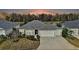 Charming home with a well-manicured lawn and serene water views from the backyard at 5449 Dray Dr, The Villages, FL 32163