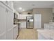 Bright kitchen featuring white cabinetry and stainless steel appliances at 5449 Dray Dr, The Villages, FL 32163