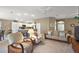 Open living area with view to kitchen, featuring neutral tones and comfortable seating at 5449 Dray Dr, The Villages, FL 32163