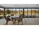 Screened-in patio with ceiling fans, outdoor dining set and beautiful lake views at 5449 Dray Dr, The Villages, FL 32163