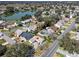 An aerial view showing neighborhood with a serene lake in the background, showcasing the community at 1001 Del Rio Dr, The Villages, FL 32159