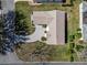 Overhead view of a well-kept property featuring meticulous landscaping, a paved driveway, and a serene setting at 1001 Del Rio Dr, The Villages, FL 32159