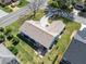 An aerial view of the house showcasing its manicured lawn, screened-in porch, and outdoor patio area at 1001 Del Rio Dr, The Villages, FL 32159