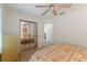 Bright bedroom with mirrored closet doors and a ceiling fan, creating a spacious feel at 1001 Del Rio Dr, The Villages, FL 32159