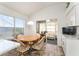 Bright breakfast nook features a wood table, four chairs, and sliding glass doors to the enclosed lanai at 1001 Del Rio Dr, The Villages, FL 32159