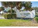 Entrance to the Rio Grande Gathering pool featuring manicured landscaping and an inviting sign for a community amenity at 1001 Del Rio Dr, The Villages, FL 32159