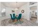 Cozy dining area with glass table, colorful rug, and natural light at 1001 Del Rio Dr, The Villages, FL 32159