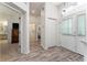 Bright entryway featuring wood-look flooring, white walls, and views into other rooms at 1001 Del Rio Dr, The Villages, FL 32159