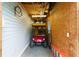 Golf cart parked in an open garage space, with lighting for a convenient storage solution at 1001 Del Rio Dr, The Villages, FL 32159