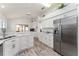 Bright eat-in kitchen with marble countertops, stainless appliances and wood-look floors at 1001 Del Rio Dr, The Villages, FL 32159