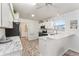 Clean, all-white kitchen with marble countertops, stainless appliances, and ample lighting at 1001 Del Rio Dr, The Villages, FL 32159