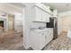 Bright kitchen with stainless steel appliances, marble countertops, and wood-look floors at 1001 Del Rio Dr, The Villages, FL 32159