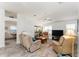 Cozy living room with vaulted ceilings, lots of windows and a colorful area rug at 1001 Del Rio Dr, The Villages, FL 32159