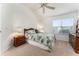 Bright main bedroom featuring neutral carpeting, ceiling fan and natural light from the window at 1001 Del Rio Dr, The Villages, FL 32159