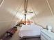 Bedroom featuring A-frame architecture, fan, and loft seating area at 10301 Us Highway 27 # 16, Clermont, FL 34711