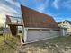 Home exterior with an interesting roofline, wooden stairs leading to an upper deck, and neutral colored siding at 10301 Us Highway 27 # 16, Clermont, FL 34711