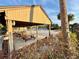 Poolside picnic tables under a gazebo and outdoor pool with lounge chairs and palm trees at 10301 Us Highway 27 # 16, Clermont, FL 34711