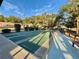 A shuffleboard court with benches and mature landscaping on a clear sunny day at 10301 Us Highway 27 # 16, Clermont, FL 34711